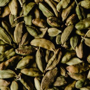 Close-up of vibrant green cardamom pods, ideal for spices and culinary ingredients.