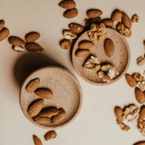 High angle view of organic almonds and walnuts on beige background. Perfect for healthy lifestyle themes.
