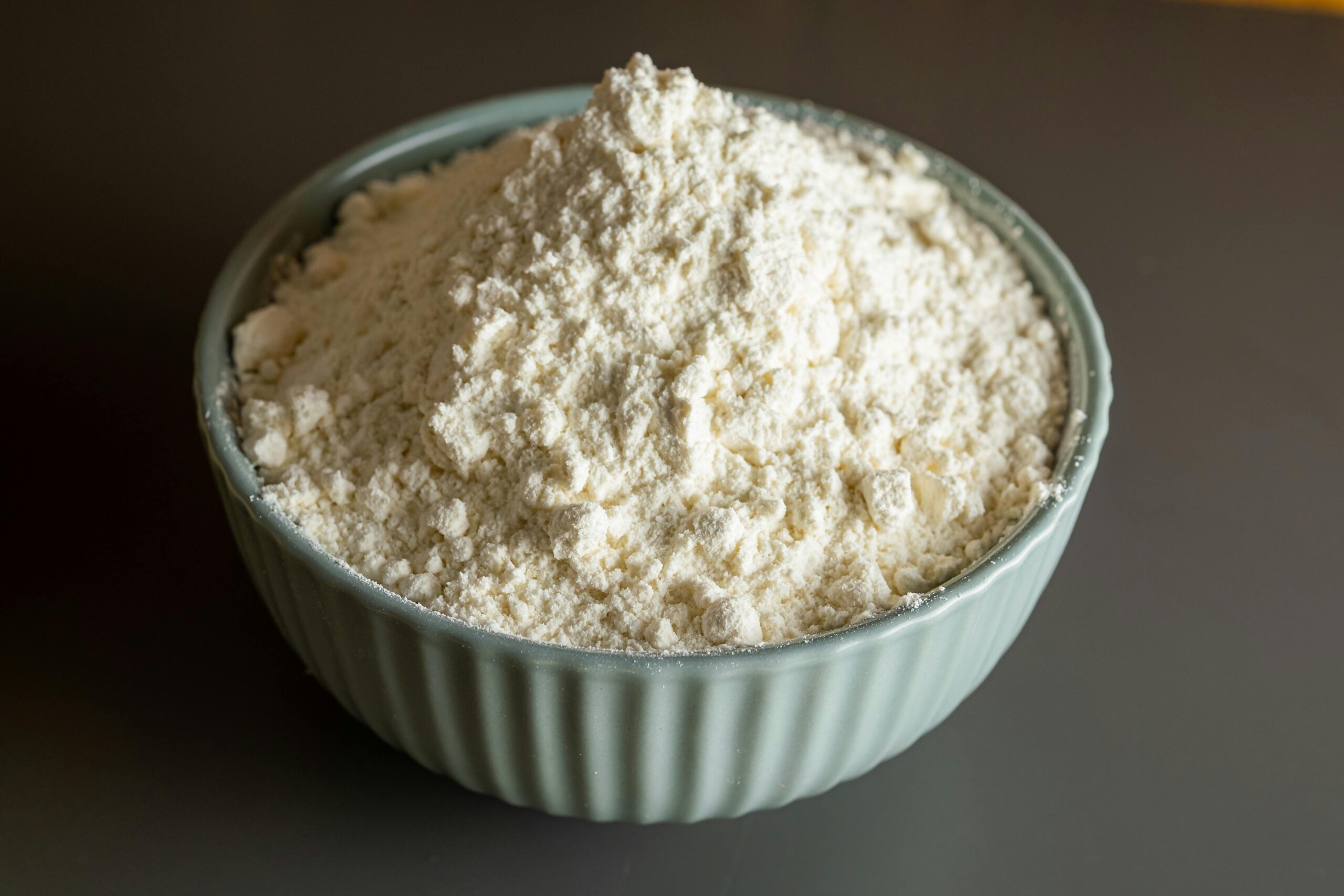 Close-up of a bowl filled with flour, perfect for culinary and baking themes.