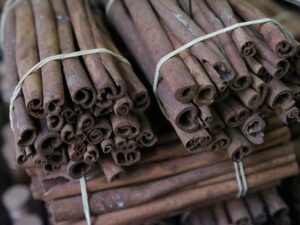 Close-up of cinnamon sticks bundled together, showcasing texture and spice aroma.