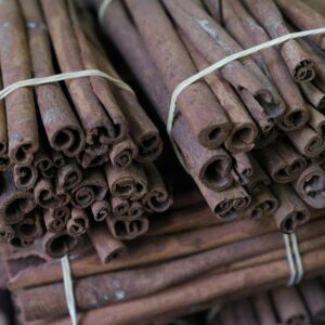 Close-up of cinnamon sticks bundled together, showcasing texture and spice aroma.