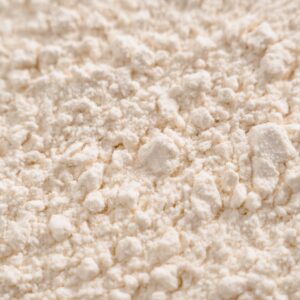 Detailed close-up of a white powder texture, resembling flour or sugar.